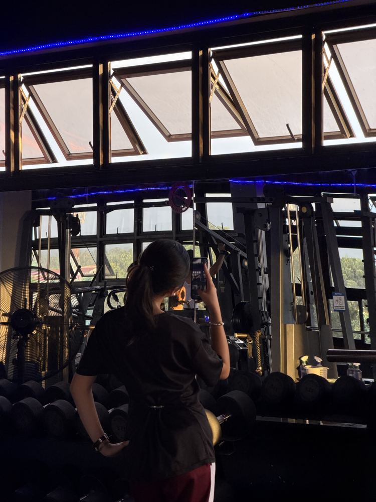 Member recording her workout by the windows